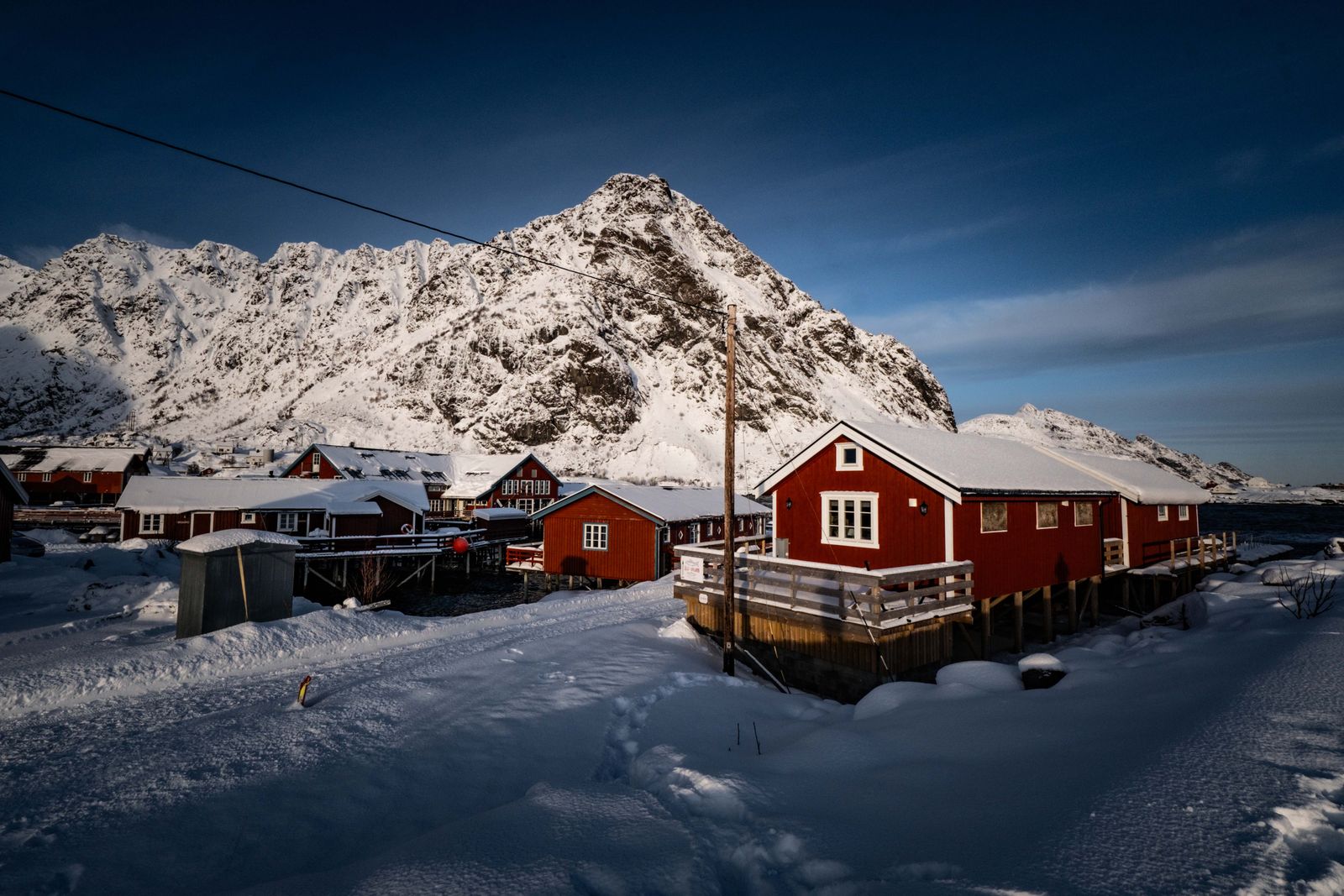 Red fishermen's cabins on stilts beneath the mountains of Lofoten