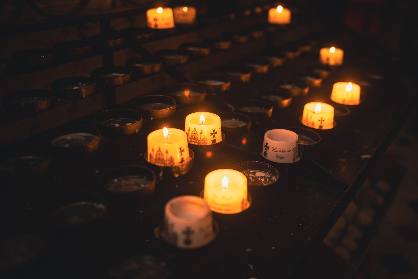Candles burning in the darkness of an old chapel
